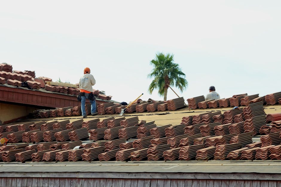 Professional assessment of roof storm damage showing damaged shingles and flashing